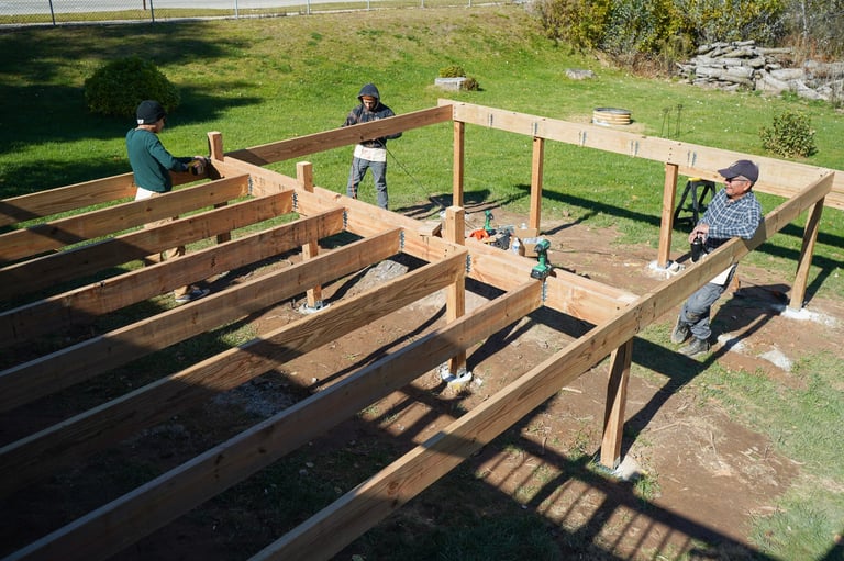 Wide shot of men building deck outdoors
