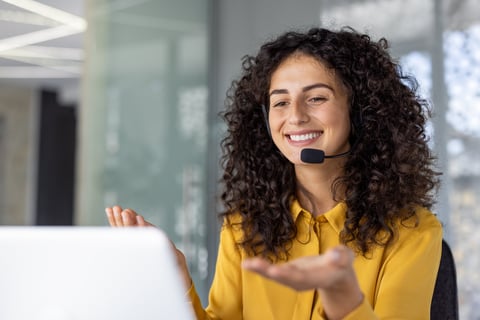 Hispanic businesswoman using headset, engaging in virtual meeting
