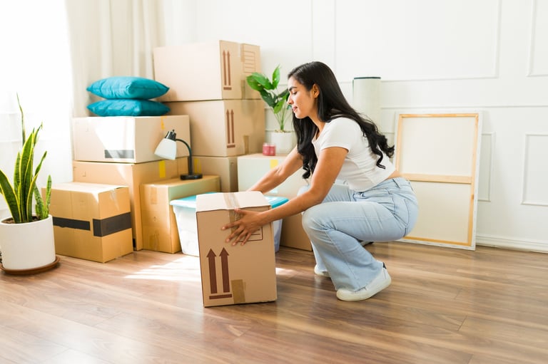 Professional mover demonstrating safe lifting technique with boxes
