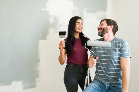 Young couple with painting tools