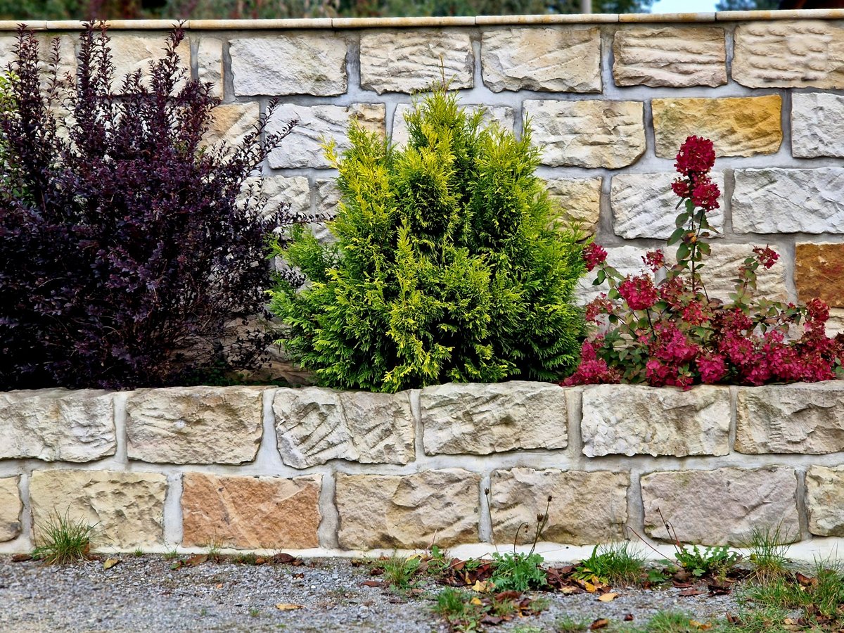 Engineered Armour stone retaining wall with integrated drainage — professional hardscaping in Ottawa