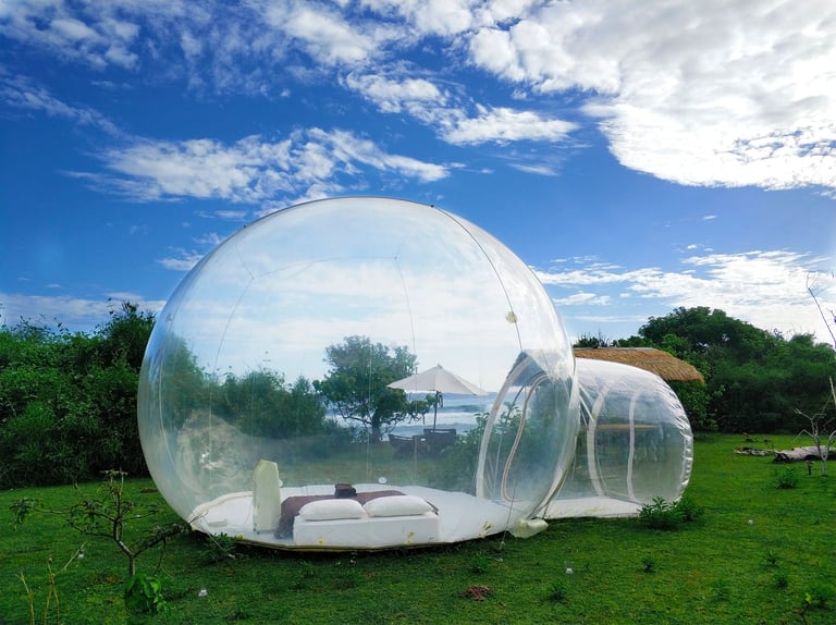 Luxury bubble tent glowing in an enchanted garden