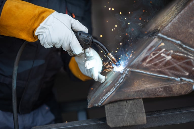 Welder joining metal parts in a Windsor workshop