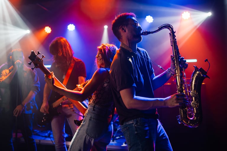 Musicians playing instruments on stage at live concert, saxophonist and bassist performing