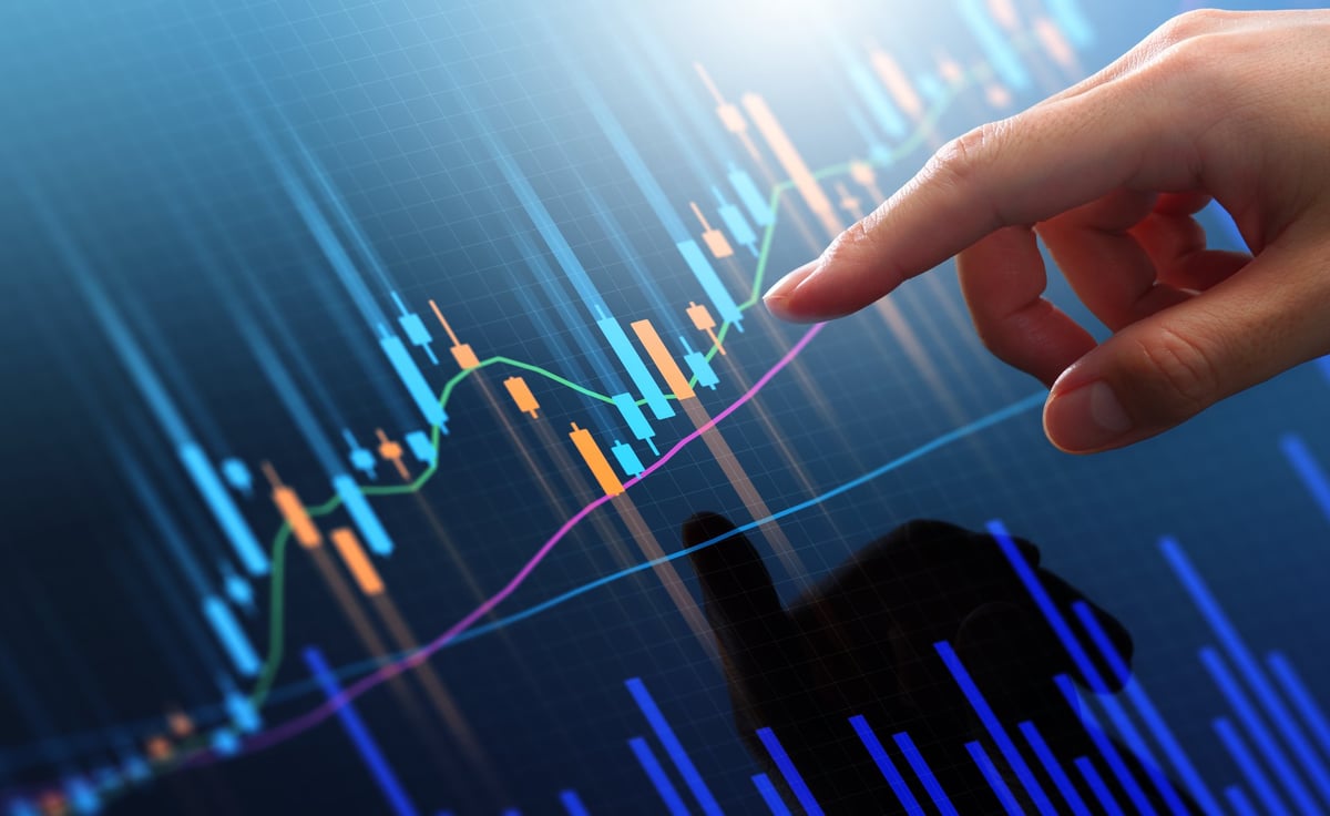 Trader analyzing stock exchange price graphs