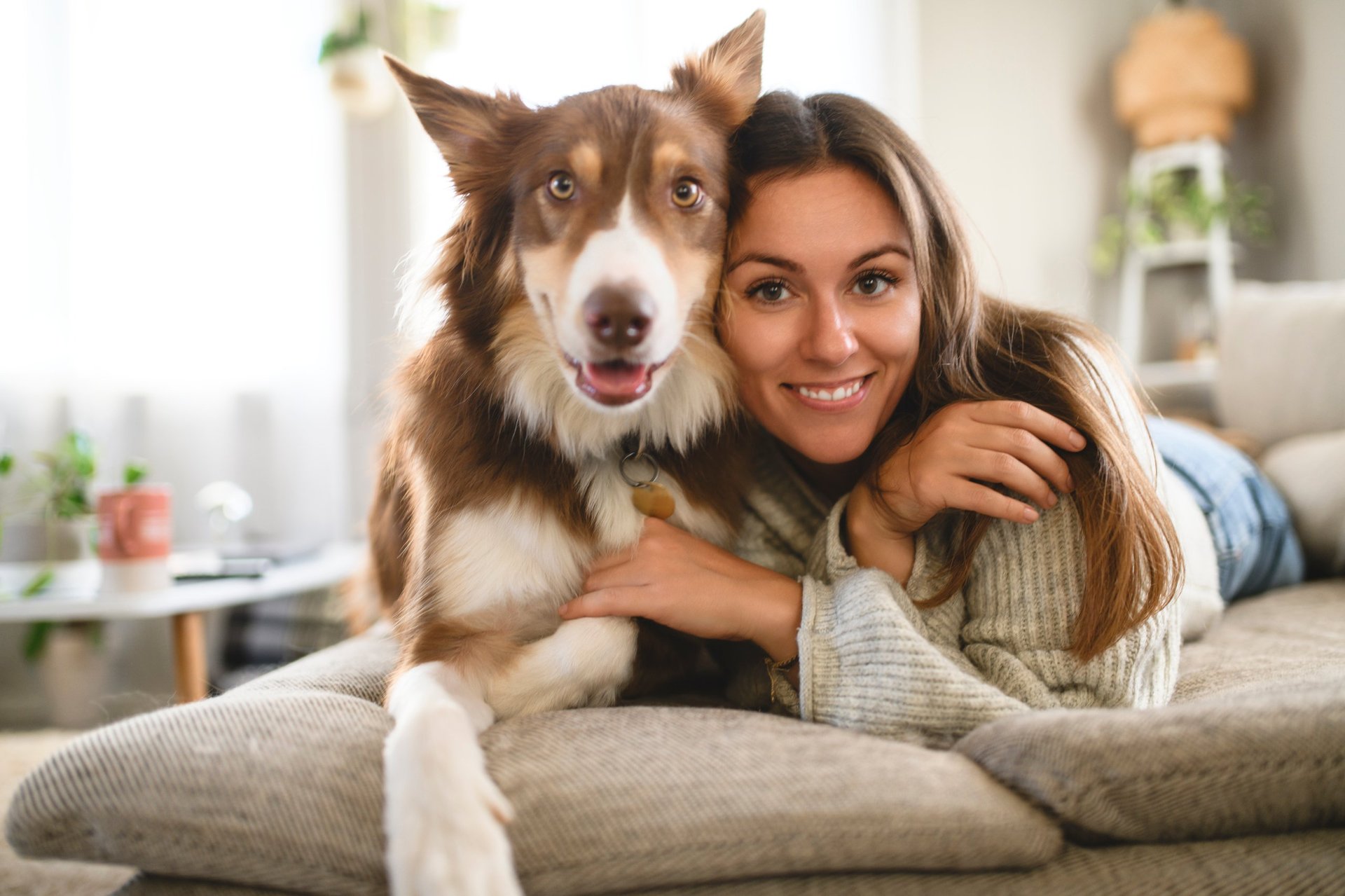 Woman with dog at home showing compassionate pet care