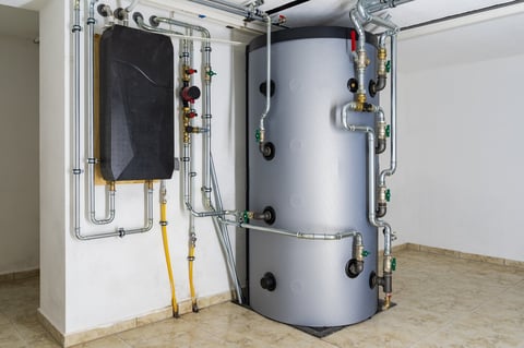 Modern buffer tank system connected to heat pump for efficient commercial heating and hot water storage