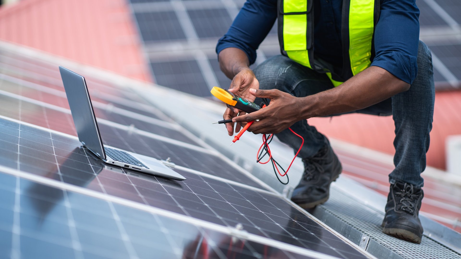 Service engineer checking solar cell on roof