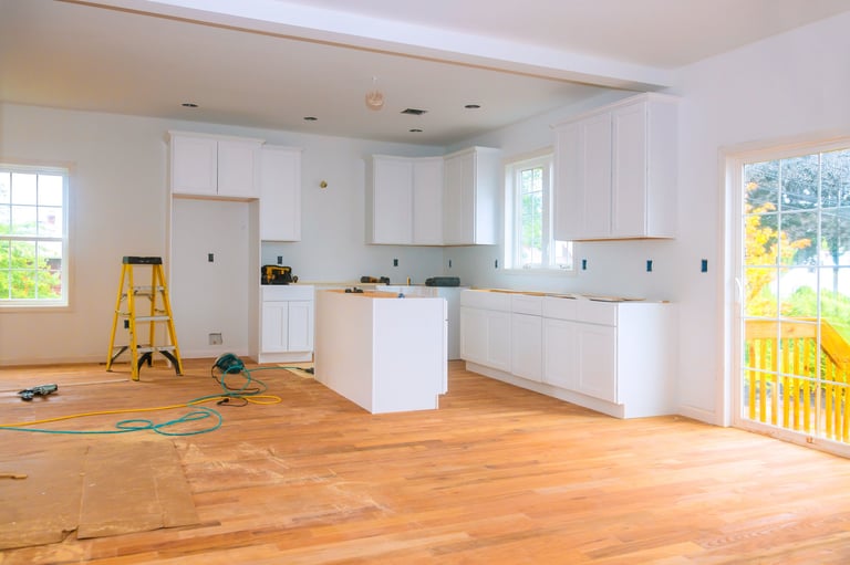 Bright airy kitchen with new white cabinets and hardwood flooring
