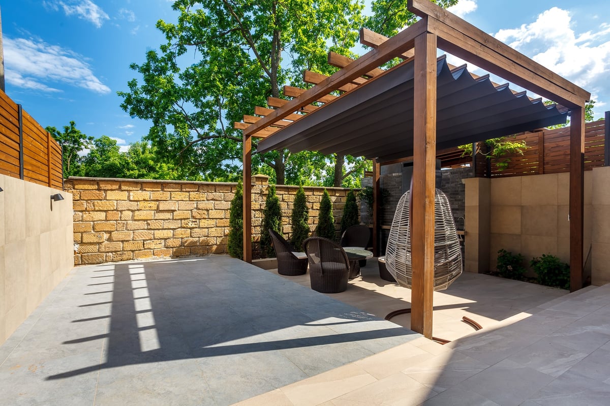 Restored wood pergola with fresh stain on beams and posts