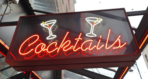 Cocktail celebration with neon-lit bar