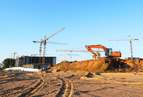 Construction site with buildings under construction and tower cranes
