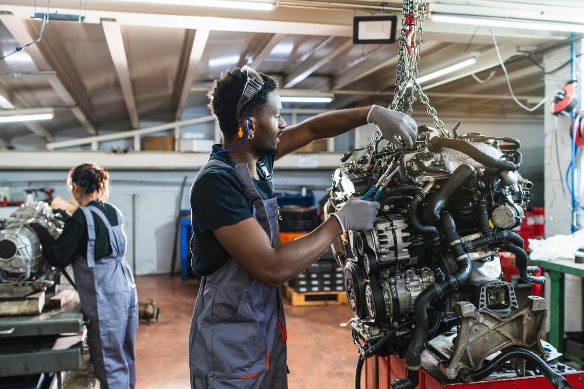 Lighthouse Milton students learning automotive systems and tools under instructor supervision