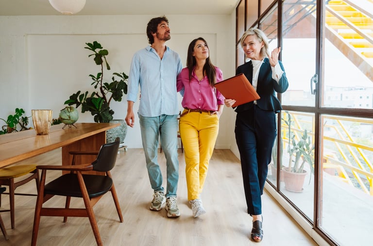 Real estate agent showing apartment features to young couple buying property