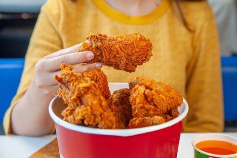 Happy customer enjoying fried chicken
