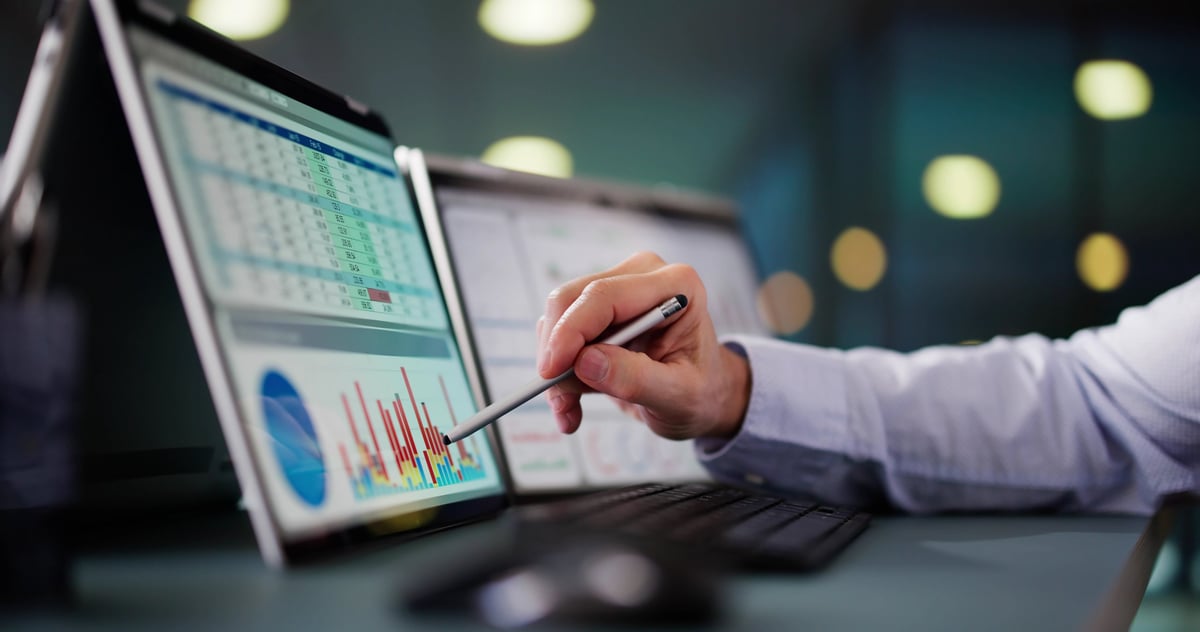 Senior advisor analyzing cost reduction KPI dashboard with executive team