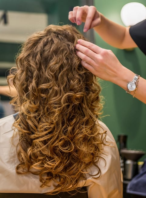 Woman with beautiful curly perm hairstyle