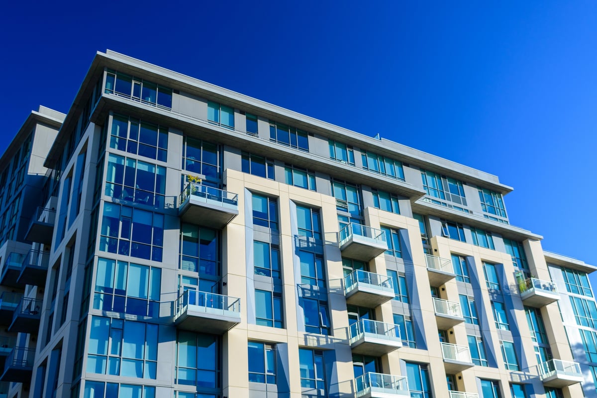 Exterior of a modern apartment building with stacked balconies