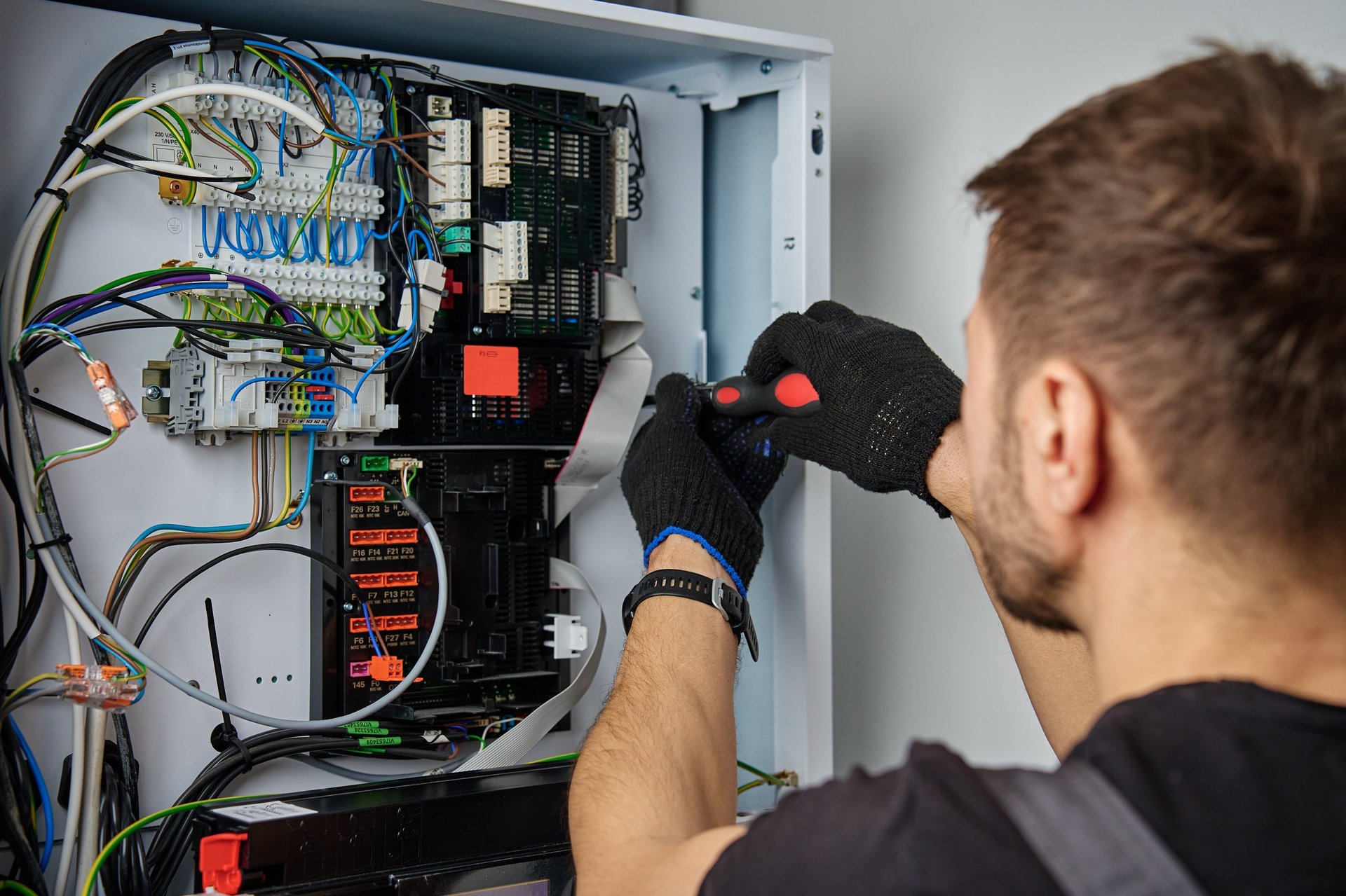 Licensed electrician working on heat pump installation