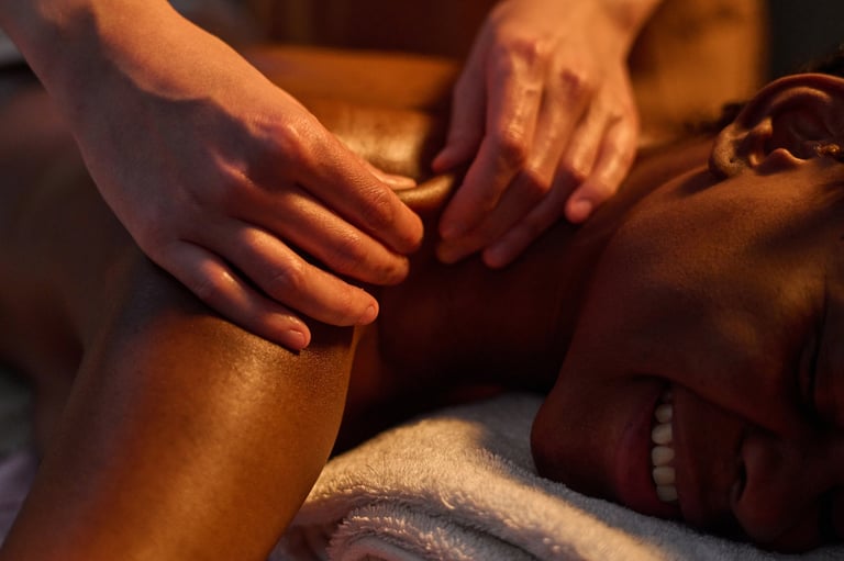Therapist's hands working into a client's shoulder during a deep tissue session