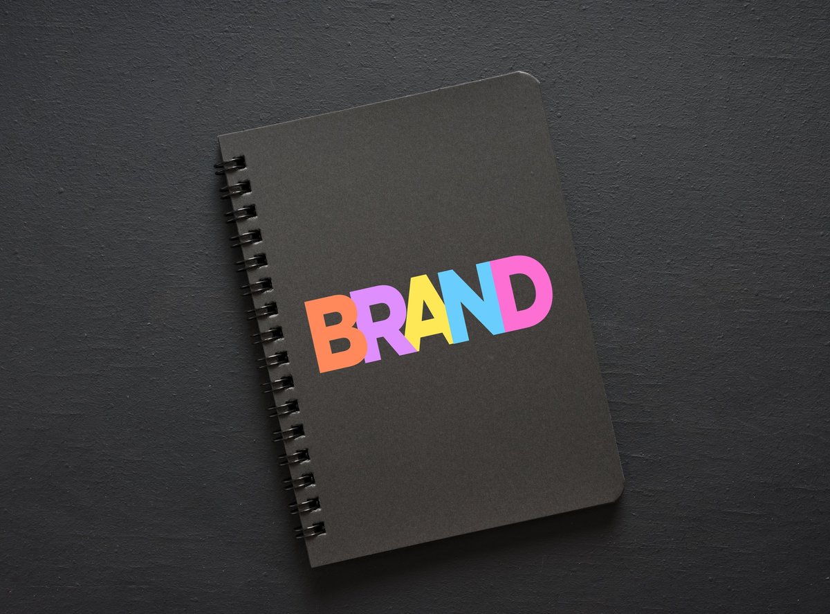 The word brand composed of colourful letters on a notebook, representing branding strategy