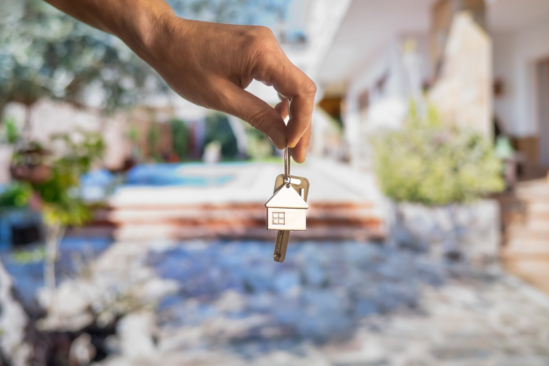 House keys with new home in background