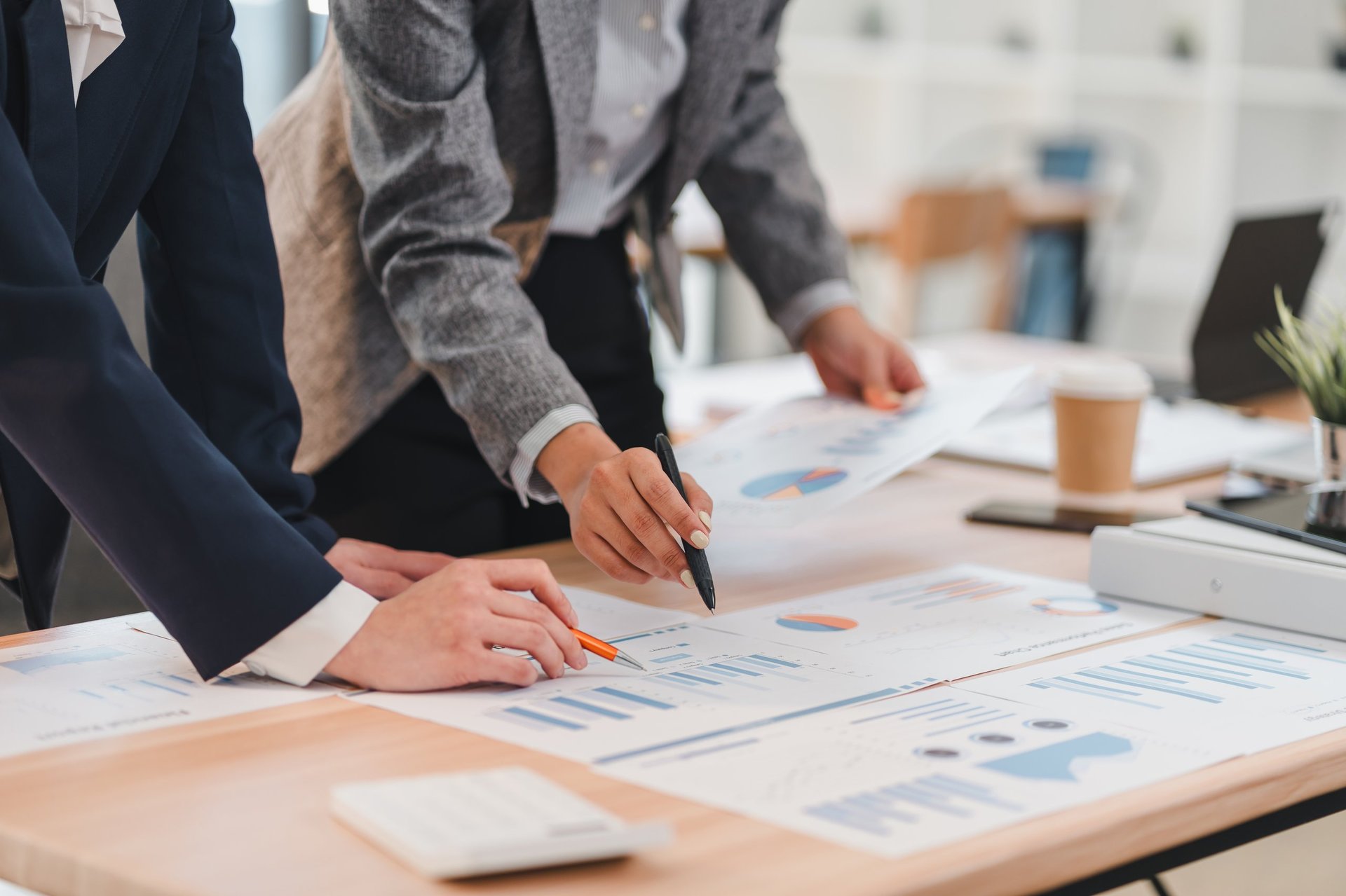Business professionals analyzing financial charts for tax reduction strategy