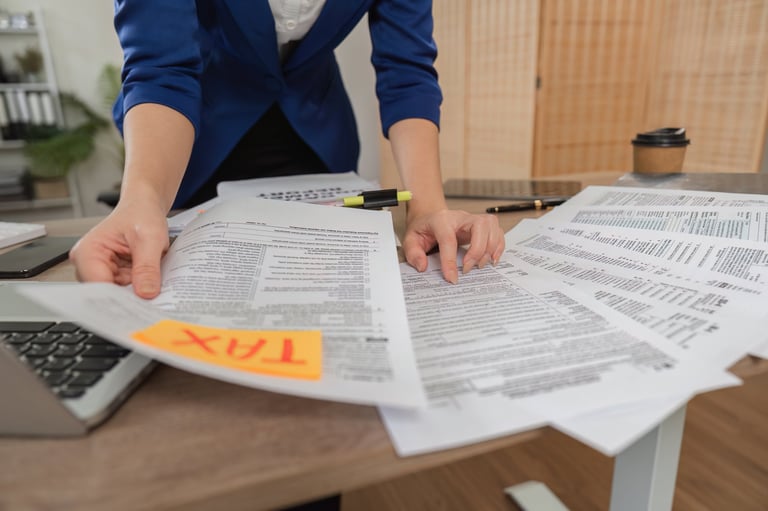 A professional woman sorting through tax documents in a contemporary office setting