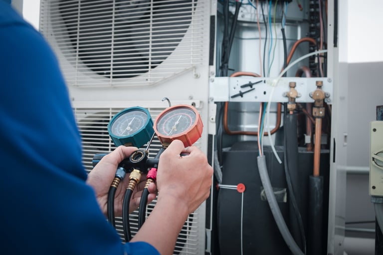 Cold Front HVAC technician checking air conditioner