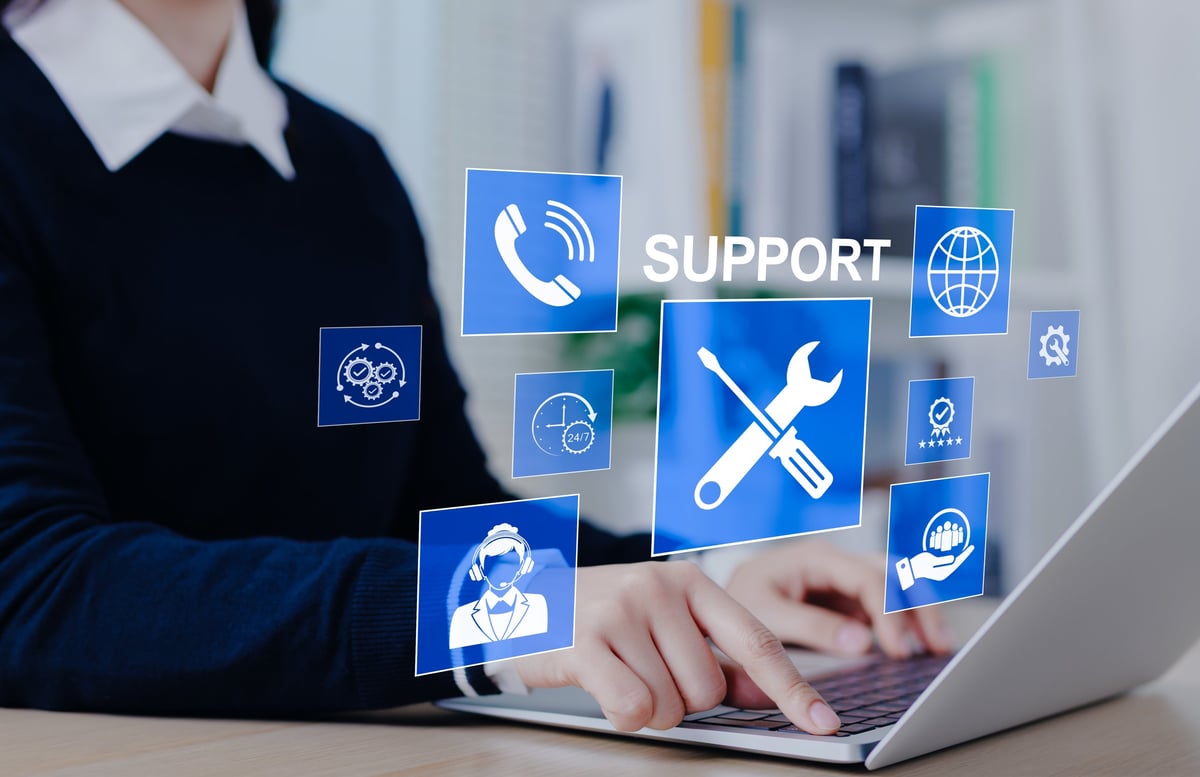 Small business owner getting technical support on their laptop, representing friendly IT help for everyday business problems