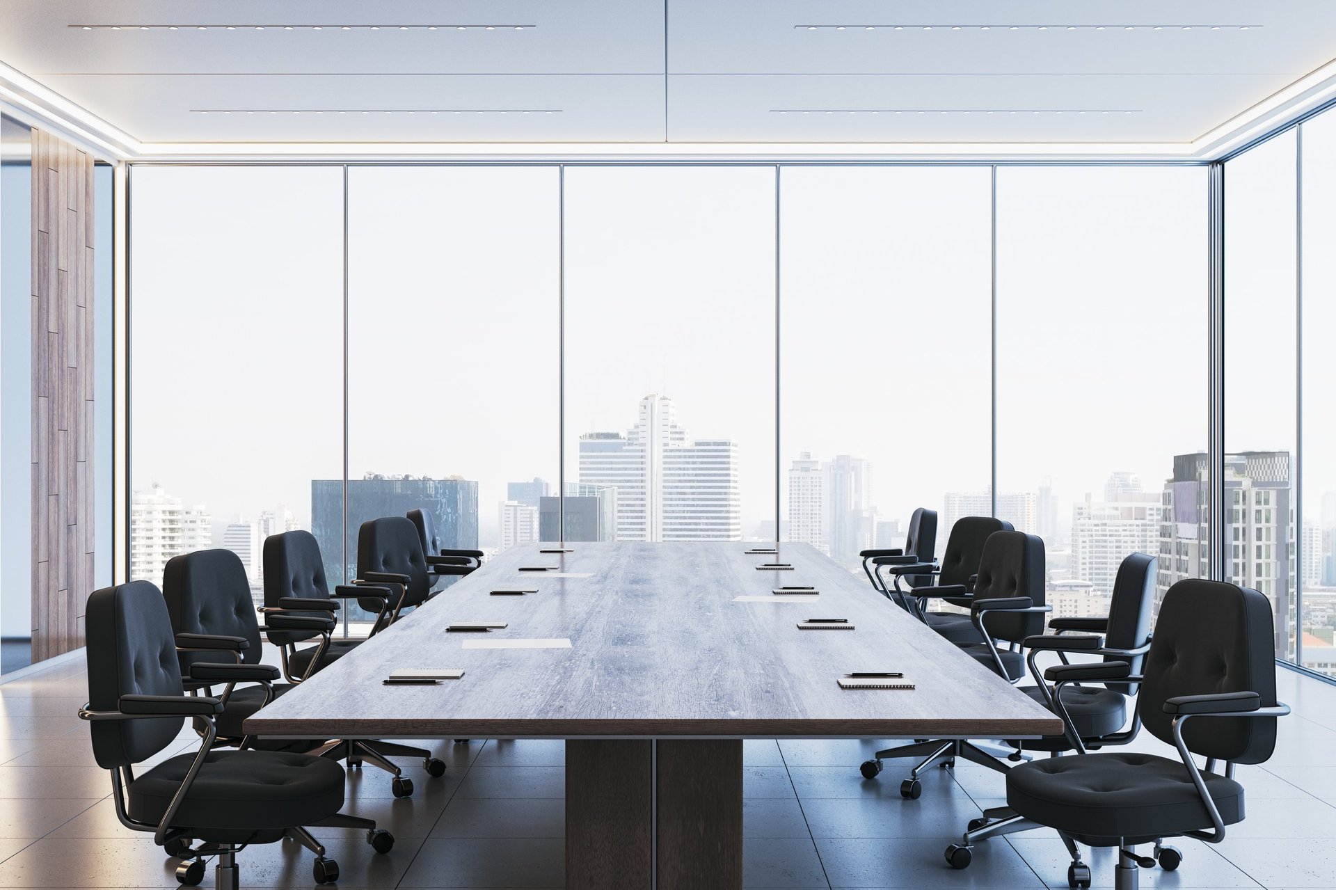 Spacious corporate boardroom with executive chairs and city skyline view