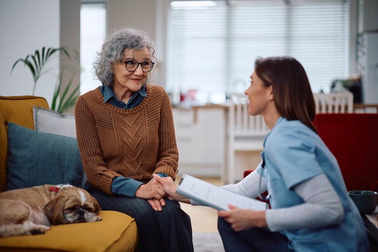 Happy senior woman with her caretaker at home