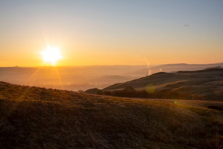 Golden sunrise over rolling hills from an early morning hike, fresh start metaphor for beginning your investing journey today