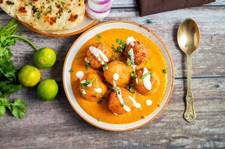Malai kofta in tomato-cashew gravy