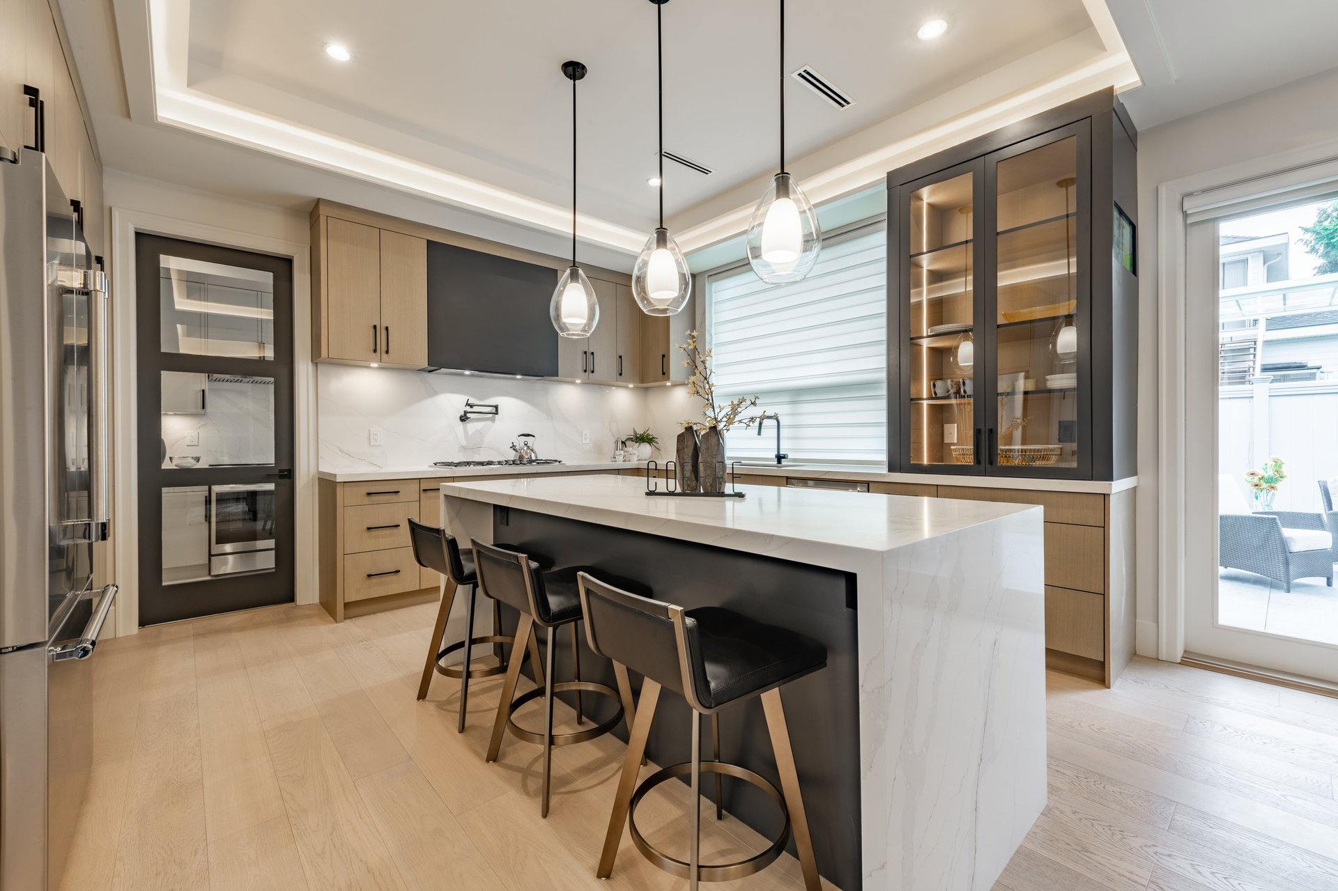 Beautiful modern kitchen renovation with white countertops and wooden cabinets