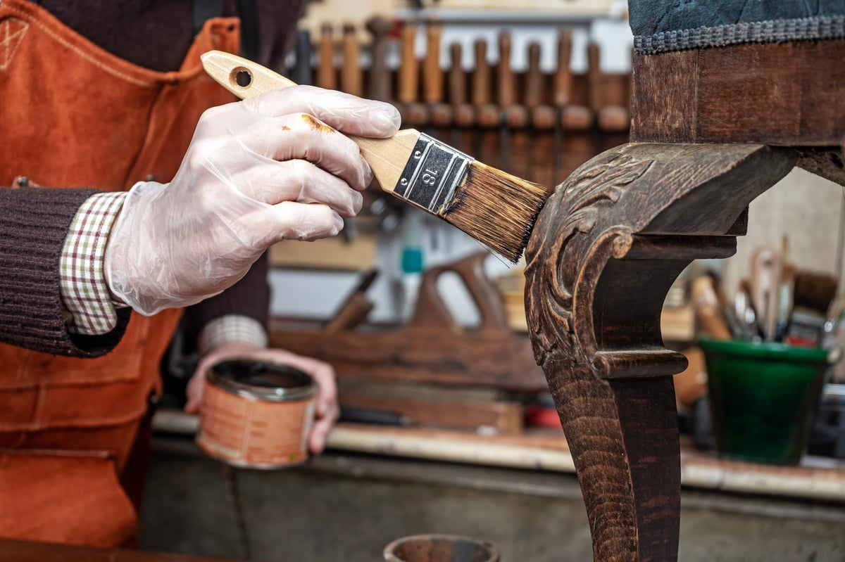 Artisan restoring antique furniture