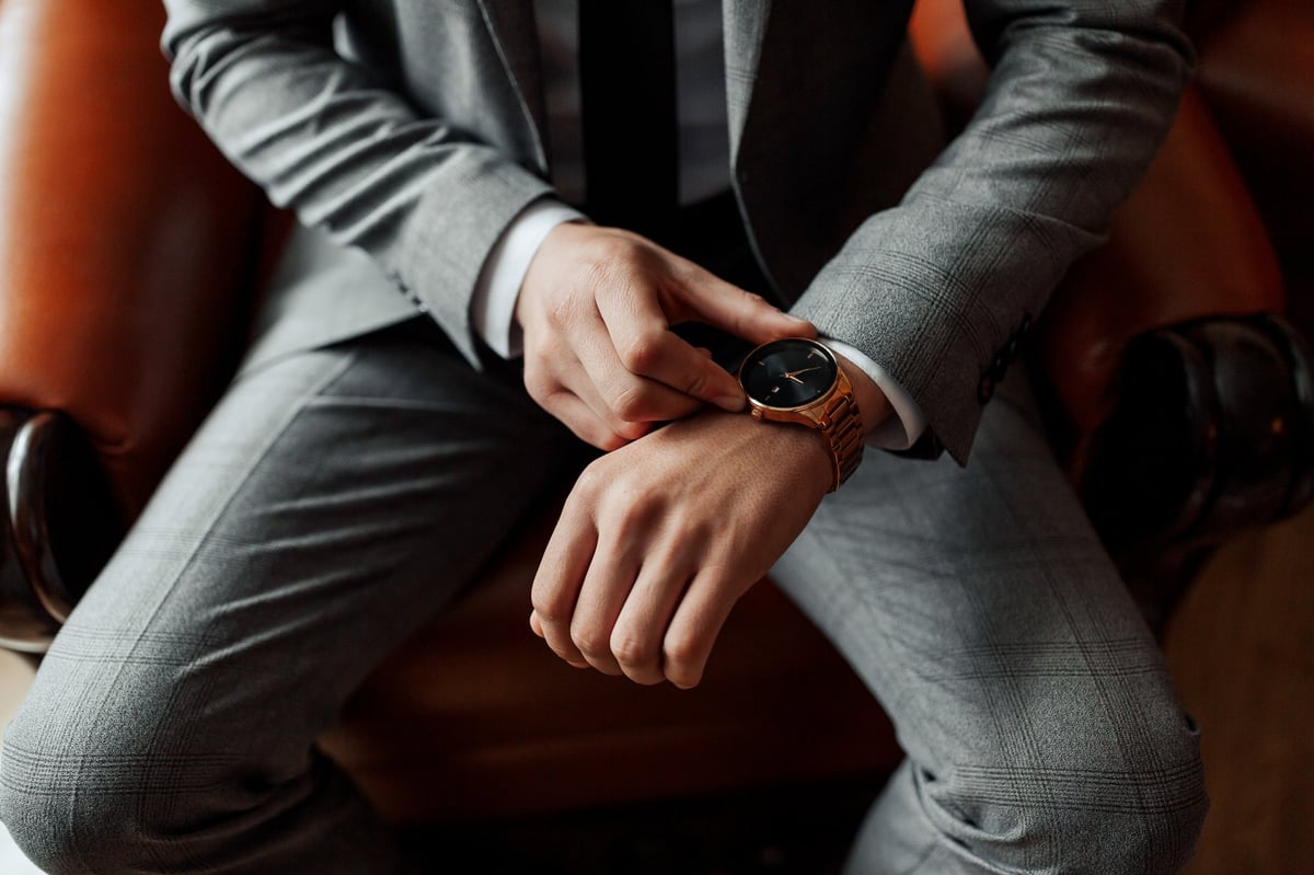 Professional in suit checking his watch
