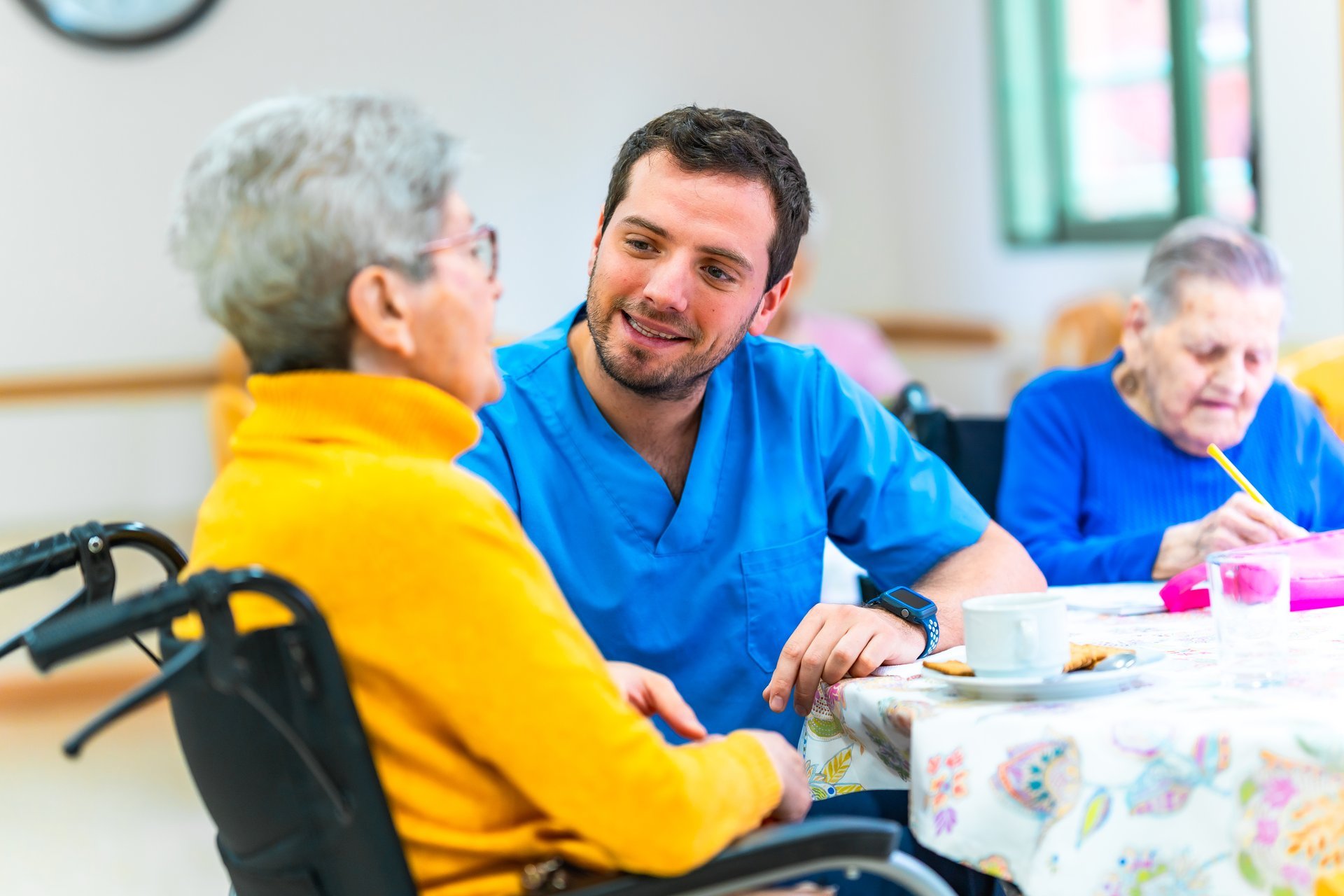 Caregiver engaging with elderly woman
