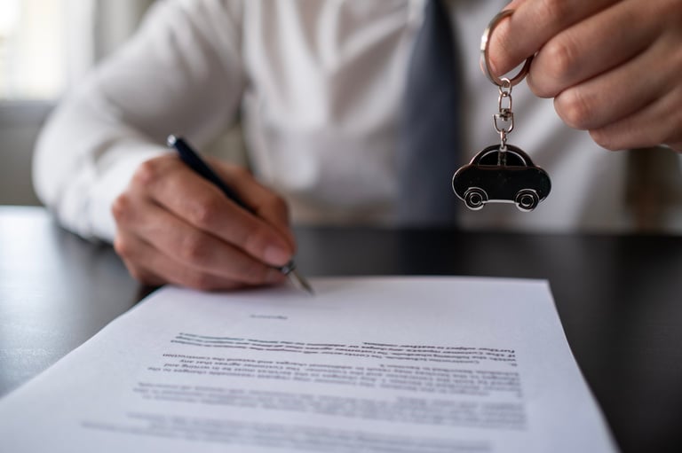 Salesman handing key to customer after successful deal
