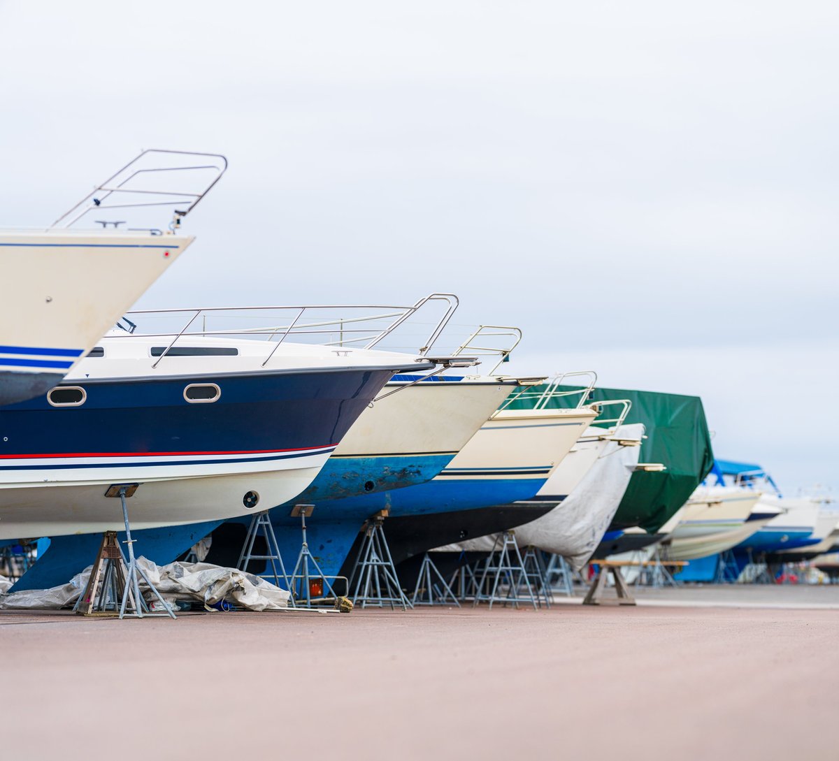 Row of docked boats resting on stands