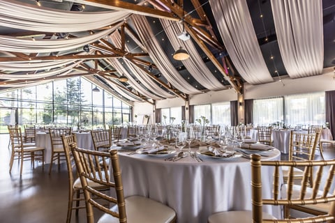 Wedding setting with decorated tables in modern venue