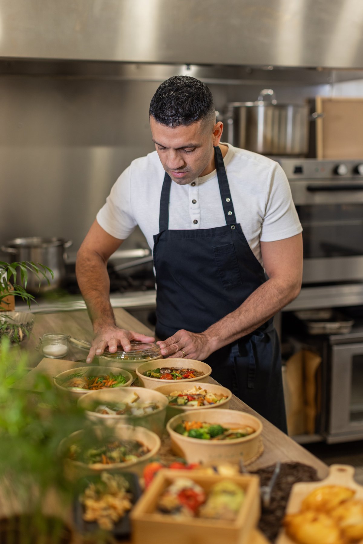Chef preparing takeaway meals in a professional kitchen