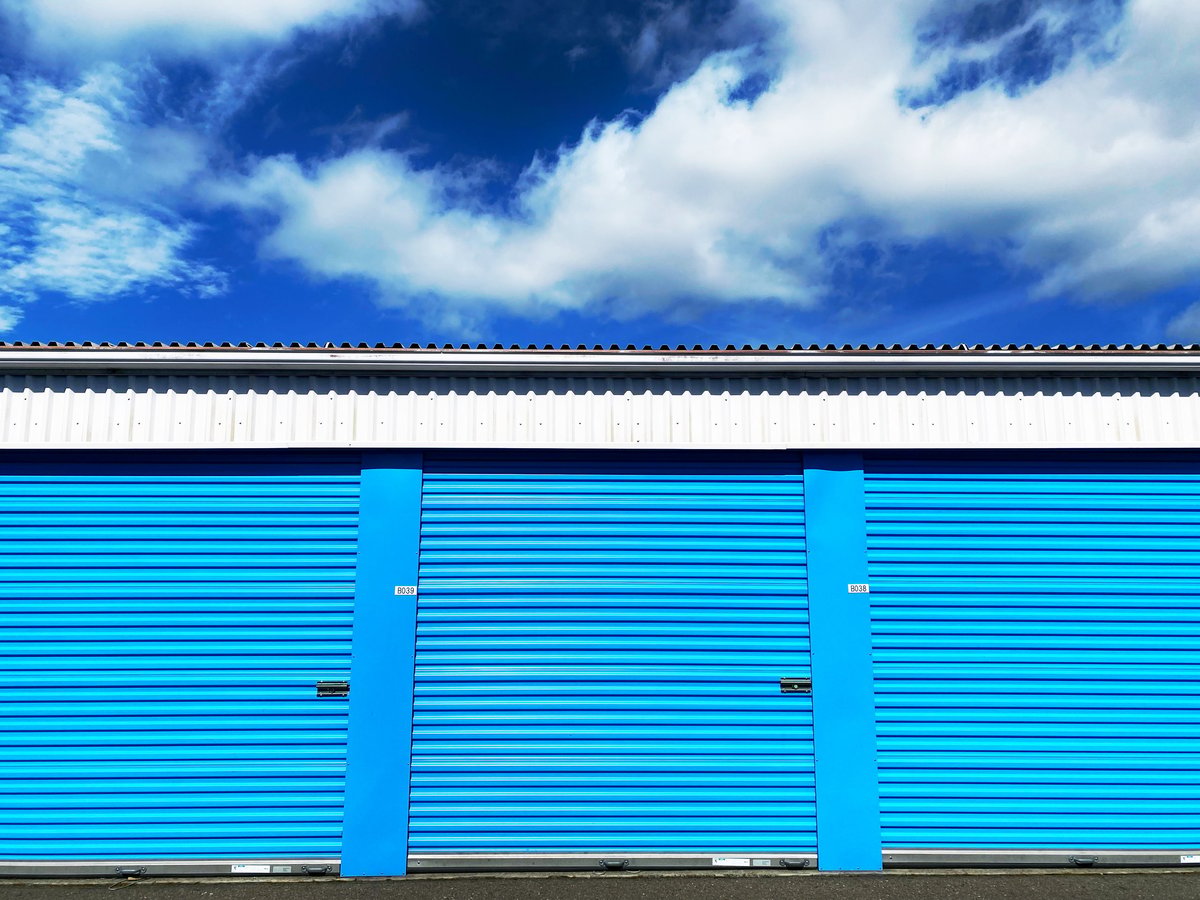 Blue self storage facility under a deep blue sky