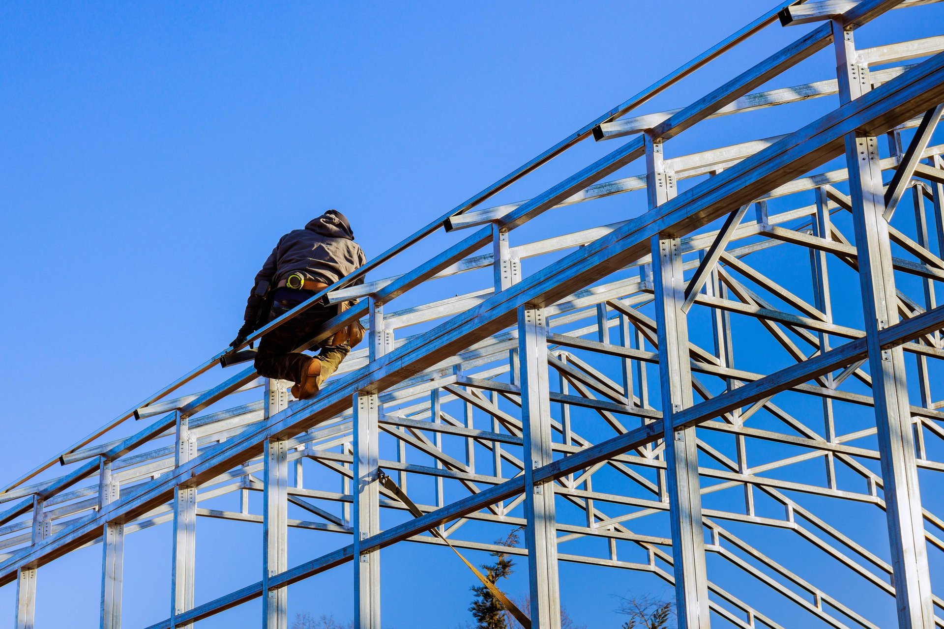 Construction worker assembling framework metal structure