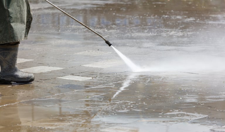 Pressure washing concrete sidewalk — removing dirt and grime