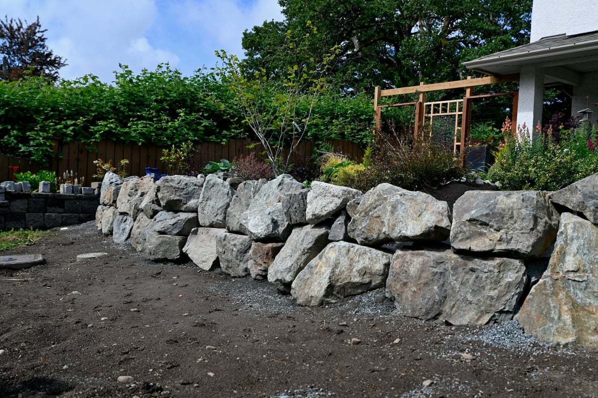 Professional landscaping crew grading soil for proper drainage on an Ottawa property