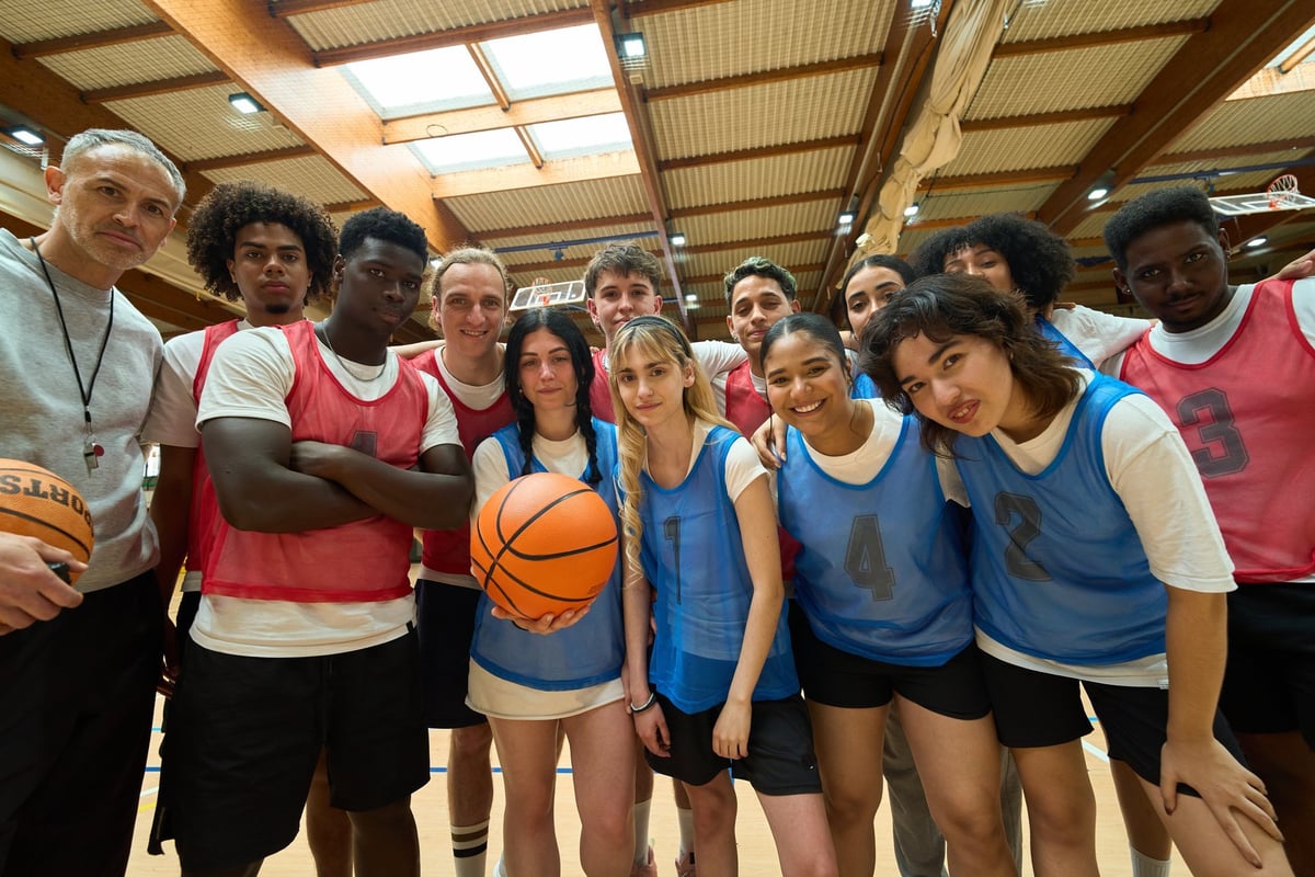 Lighthouse student-athletes and their coach gathered together in a gymnasium