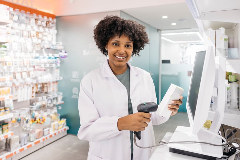 Young pharmacist scanning medicine box in pharmacy using barcode scanner