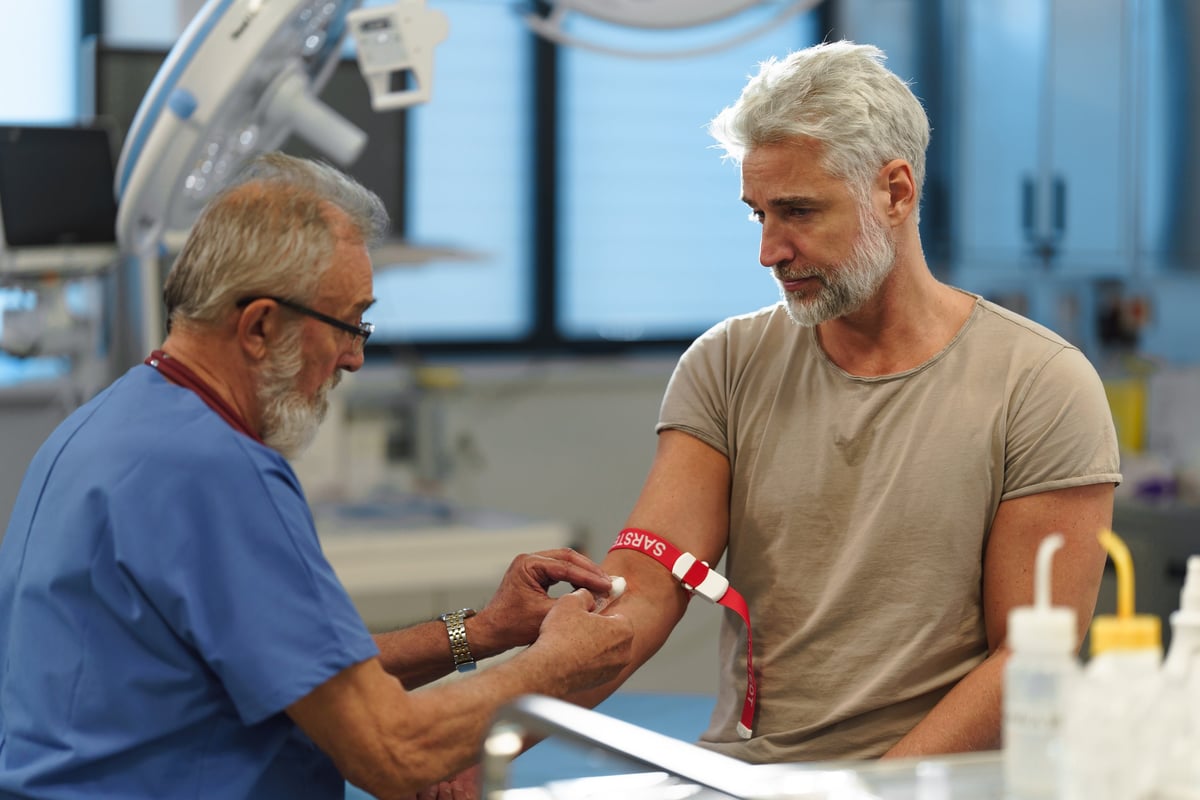 Doctor drawing blood from patient's arm for comprehensive laboratory analysis