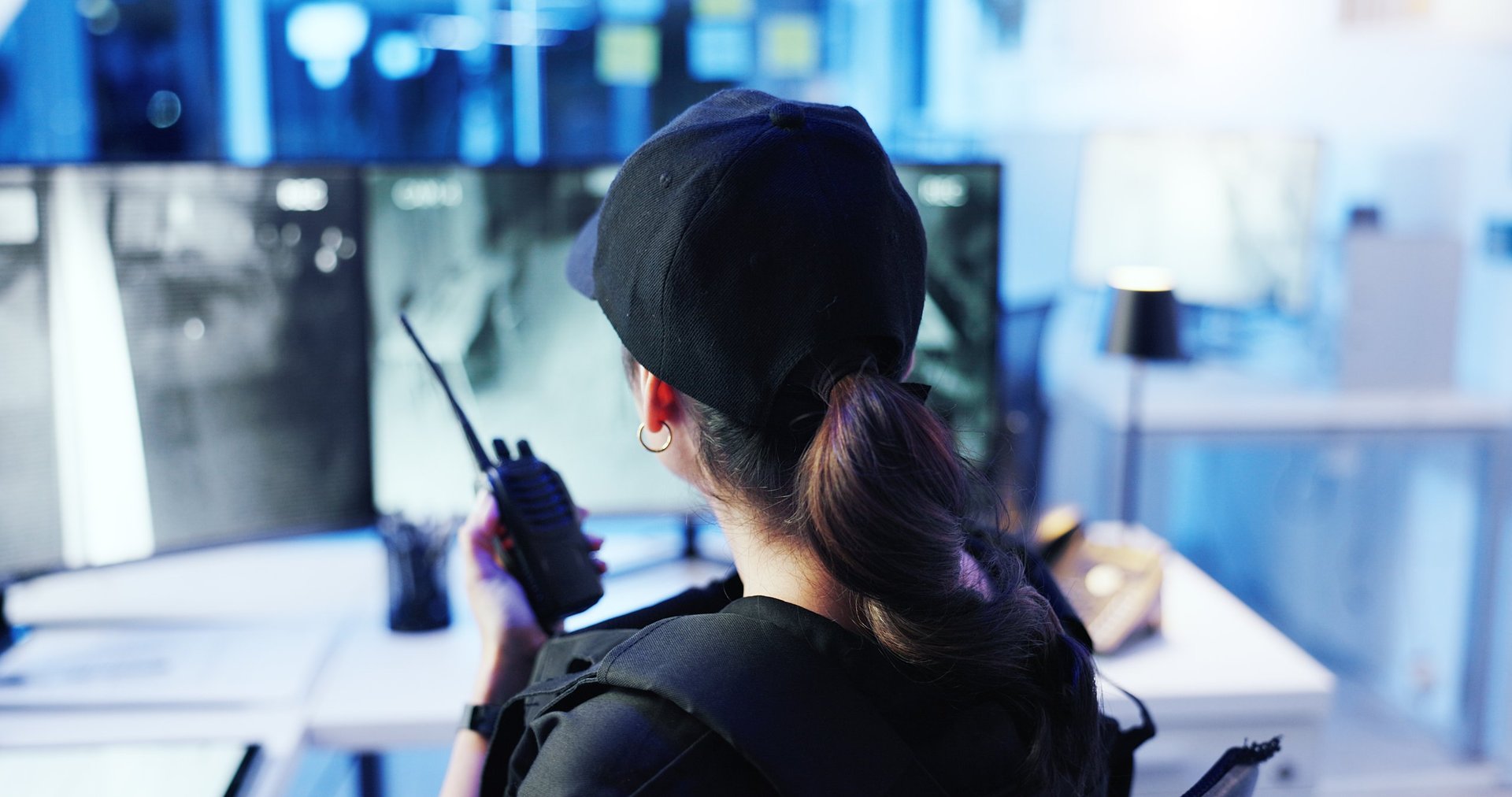 Control room operator watching CCTV at night